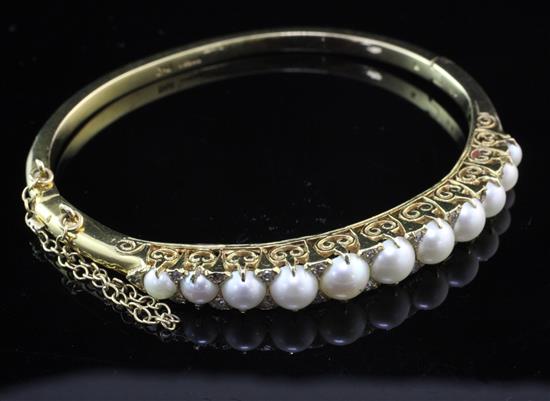 A Victorian style 9ct gold, graduated split cultured pearl and diamond set hinged bangle,